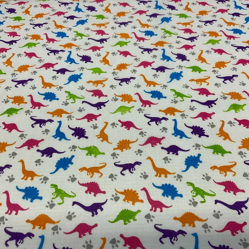 £2.50/m White Tiny Dinosaurs Children's Poly cotton printed fabric M1637