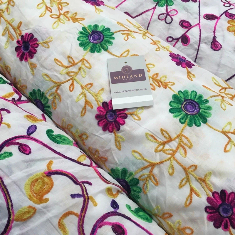 White Cotton with multicoloured wool embroidered dress fabric 54" Wide M1000